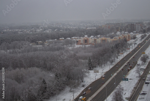 winter landscape, road leading to the city a snowy forest. View from above.selective focus