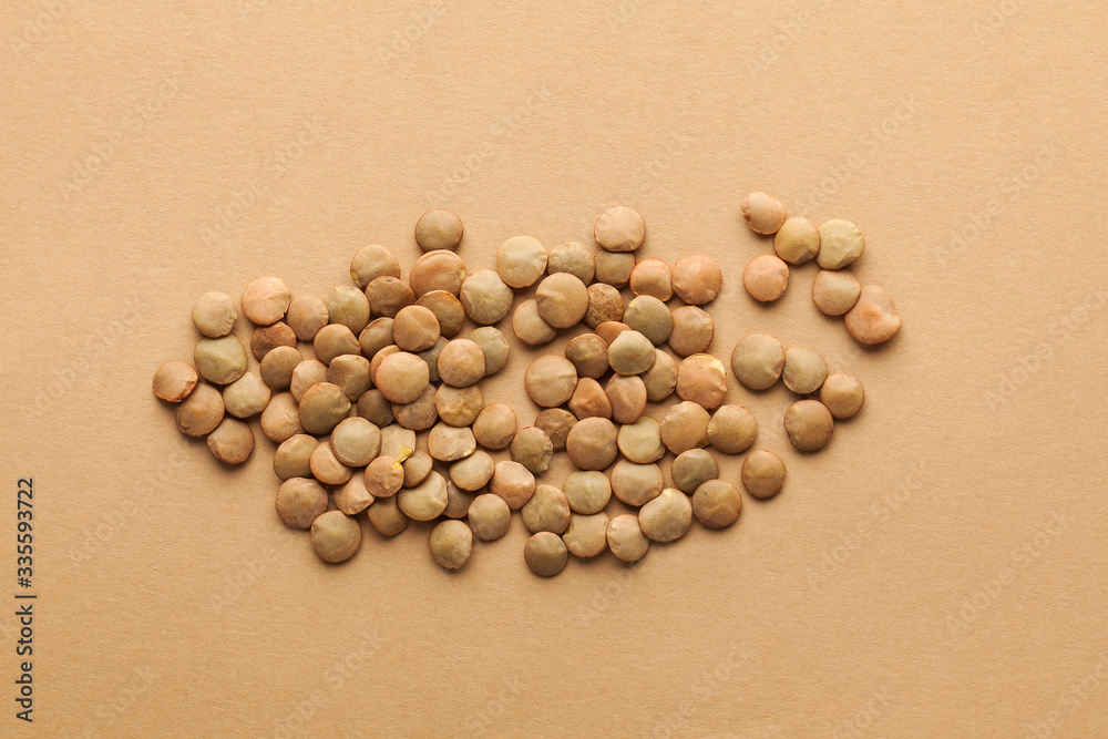  Lentils close-up on a brown background. Layout for grocery, lentil sellers. Food photo.