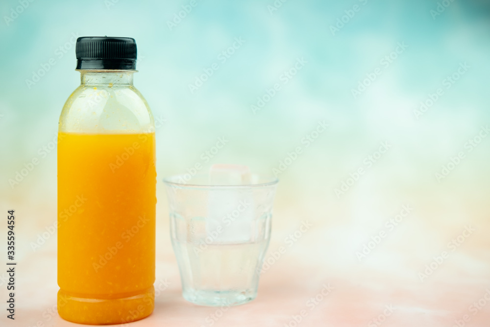 Close up of plastic bottles with fresh orange juice Close up of plastic bottles with fresh orange juice