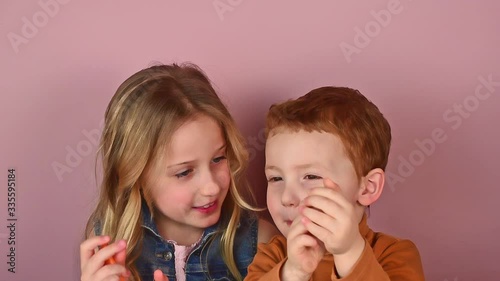The older sister teaches her charming three-year-old brother poetry
