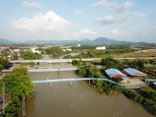 Aerial view Pedestrian, vehicle and train cross over the river at Nibong Tebal. © Cloudyew