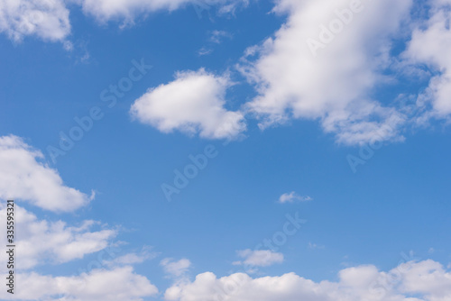 Fototapeta Naklejka Na Ścianę i Meble -  Spring blue sky with white clouds over the horizon on a sunny day background