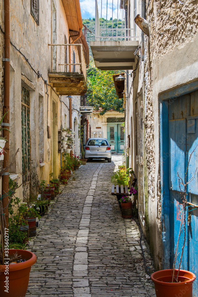 Obraz premium Cyprus village Lefkara. View of a narrow village stony street with lot of green and flower pots
