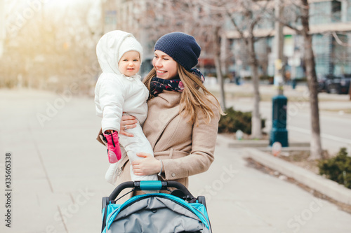Photography Happy young Caucasian mother holding baby daughter outdoor in Toronto