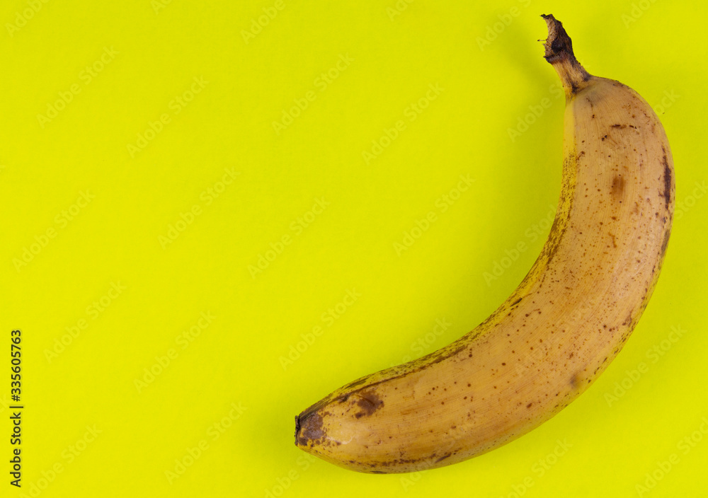 Yellow banana on a yellow background.copyspace for text Yellow banana on a yellow background.copyspace for text