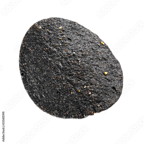 Fényképezés One black potato chip isolated on white background.