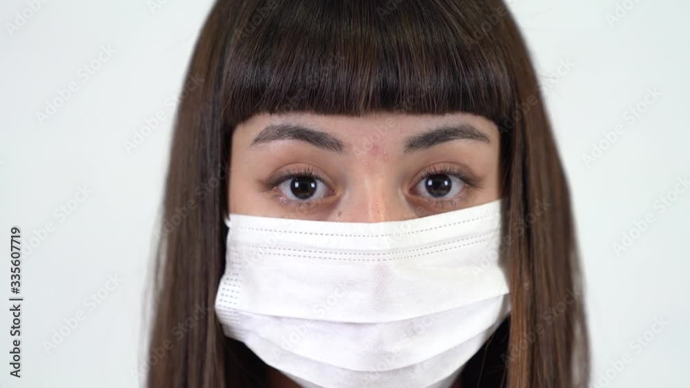 A young girl with protective mask in white background.
Coronavirus icon. Close up shot. A young girl with protective mask in white background.
Coronavirus icon. Close up shot.