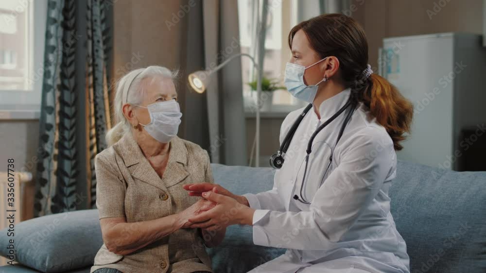 Nurse talking with elderly woman patient, during covid-19 self isolation