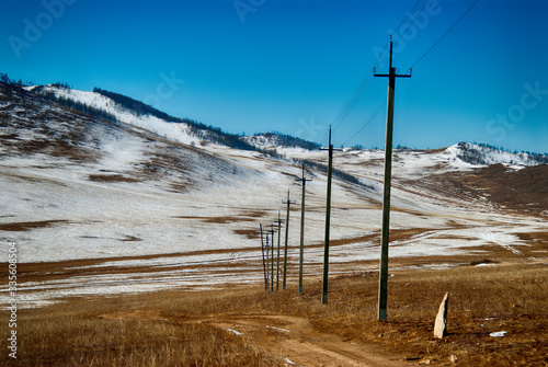 High voltage line passing along a country road © unww