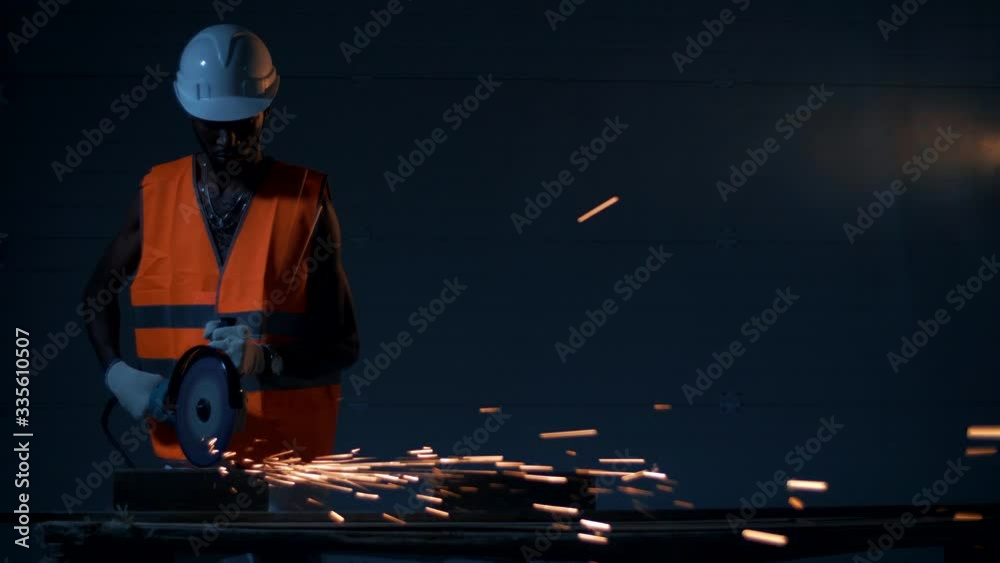 Black engineers workers work on welding metal in a dark atmosphere.
