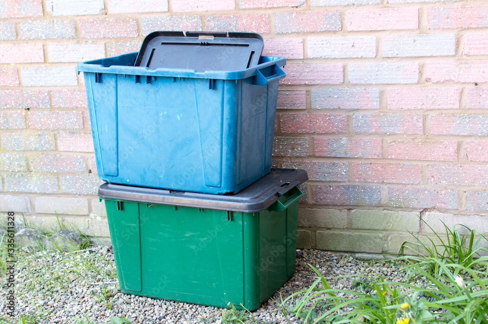 A green and blue recycling box outside a property in UK A green and blue recycling box outside a property in UK