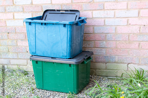 A green and blue recycling box outside a property in UK