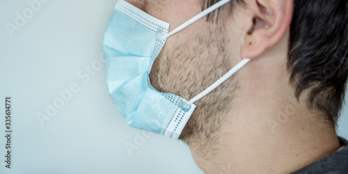 Man putting on a surgical mask photo