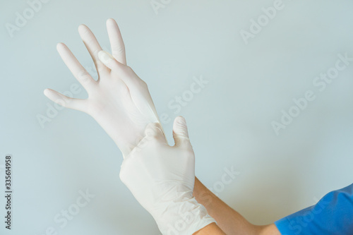 healthcare professional putting on surgical latex gloves photo