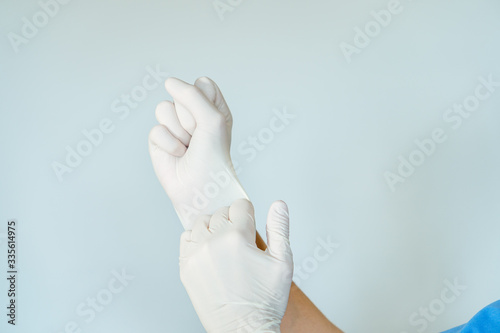 healthcare professional putting on surgical latex gloves photo