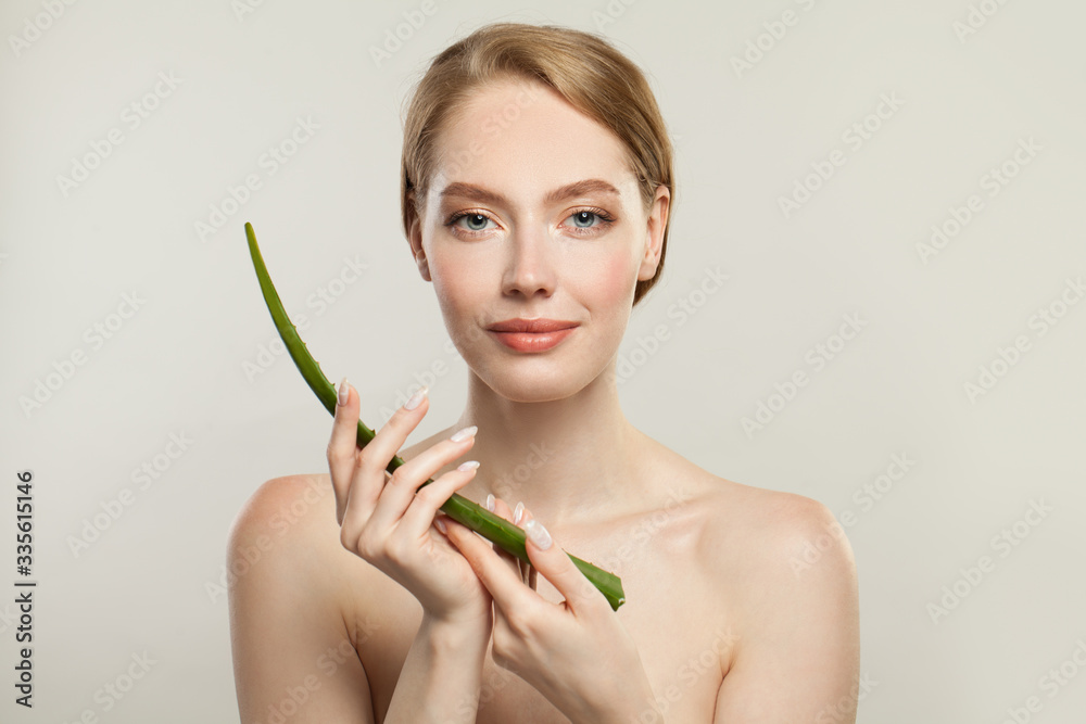 Healthy model with clear skin and aloe plant leaf. Skincare and facial treatment concept Healthy model with clear skin and aloe plant leaf. Skincare and facial treatment concept