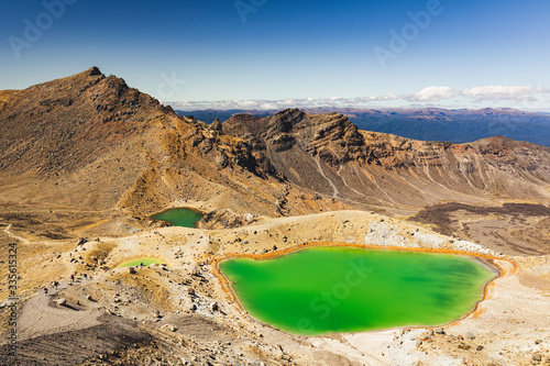 Green pools and Lava fields at Tongariro Alpine New Zealand, popular day hike in the country. This National Park is a World Heritage site