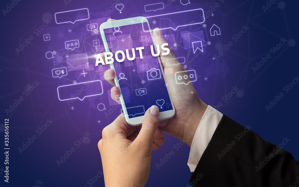 Female hand typing on smartphone with ABOUT US inscription, social media concept Female hand typing on smartphone with ABOUT US inscription, social media concept