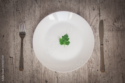 empty plate with broccoli knife and fork