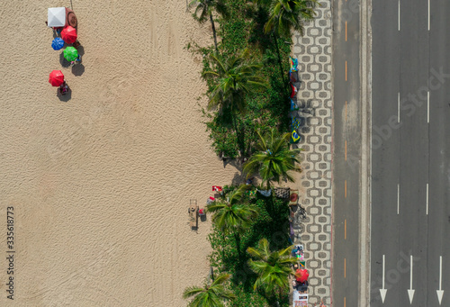 Drone shot of a street and palm trees along the beach in Rio de Janeiro Brazil