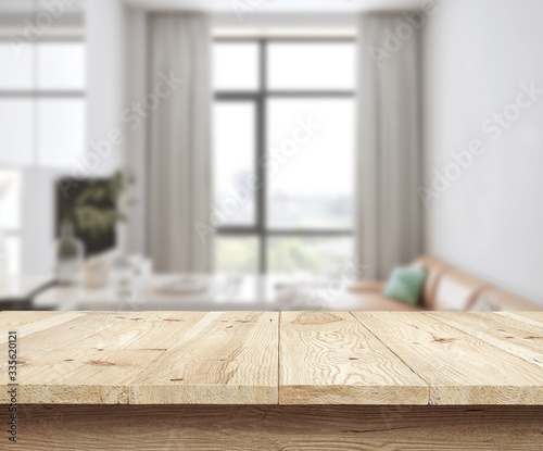 Concept wooden textured desk with blur interior.