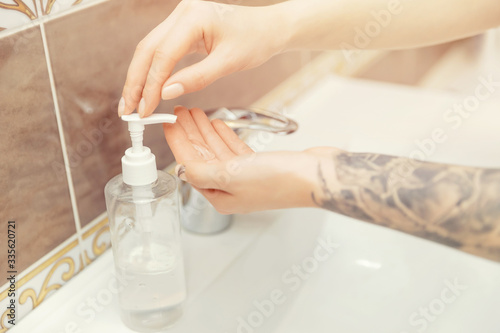 Coronavirus protection washing hands with tattoo with soap woman