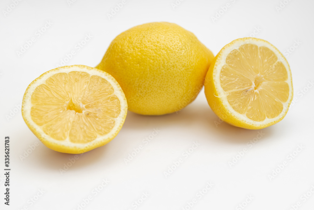 whole lemon fruit sour yellow isolated on a white background close-up and rugs on the table