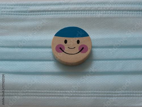 Smiley on a protective medical mask. Everything will be fine. Concept of health and safety life from coronavirus and pandemic.  photo