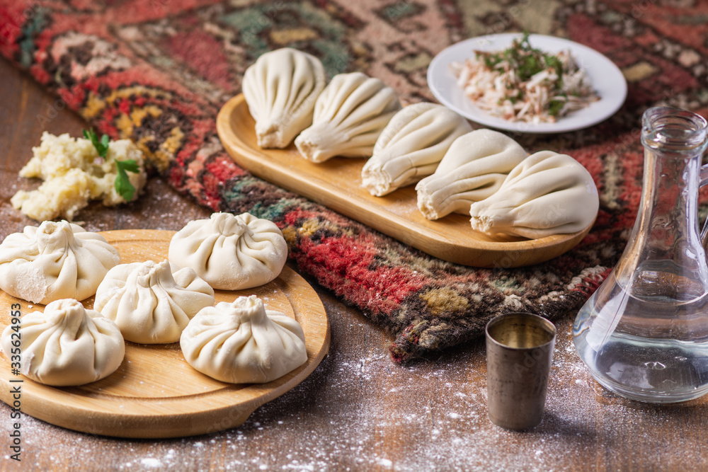 Georgian dumplings Khinkali with potato and mushroom, Vegan food, Georgian Chacha (vodka) on a wooden background