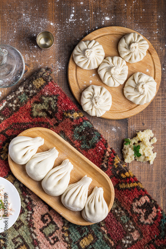 Georgian dumpling or Khinkali. Georgian homemade khinkali with mushroom and potato on cutting board. Vegan food. Top view, copy space for text