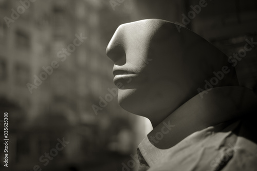 Male mannequin head in store window photo