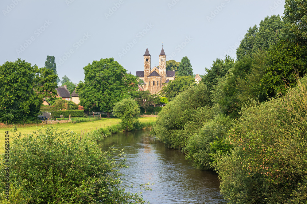 Beautiful view of the Romanesque basilica in Sint Odiliënberg village from the bidge over river Roer, Limburg, The Netherlands Beautiful view of the Romanesque basilica in Sint Odiliënberg village from the bidge over river Roer, Limburg, The Netherlands