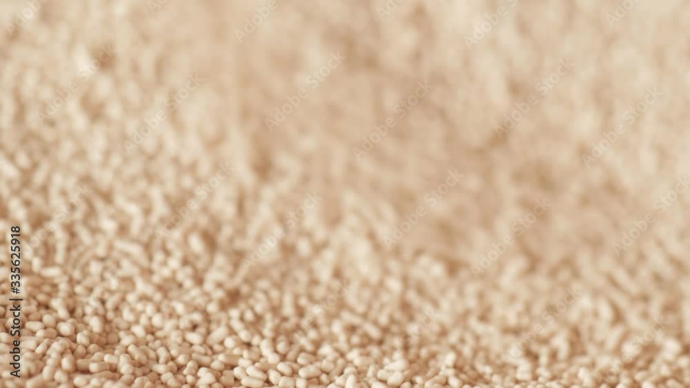 spilling pouring and scooping dry instant yeast with spoon extreme macro