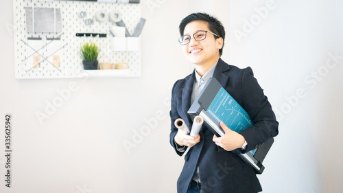 Business man wearing casual suite and holding paper roll, draft architect. Look forward using internet for work from home online working not go office. He look smart processional worker. 