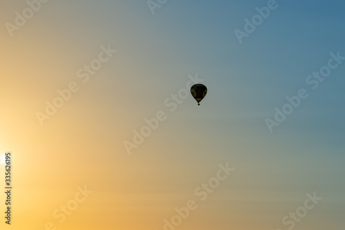 Hot Air Balloon flies towards the sunset
