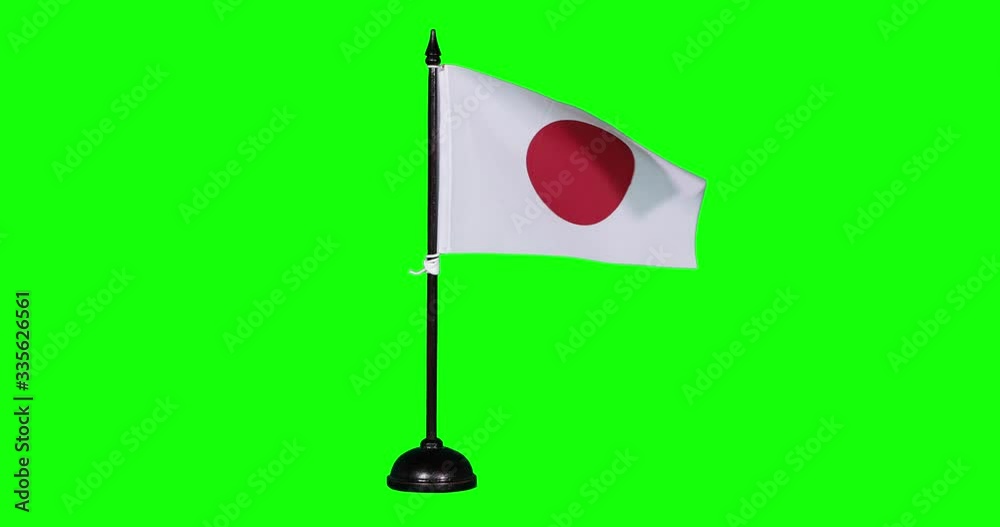 Miniature flag of Japan fluttering on a flagpole Miniature flag of Japan fluttering on a flagpole