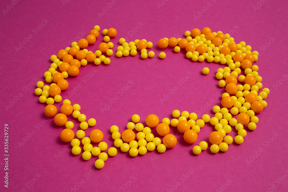 colorful pills for viral diseases in circle frame with copyspace for text. Prevention of influenza, coronavirus, covid-19. yellow, orange vitamins on purple background. medical healthcare concept