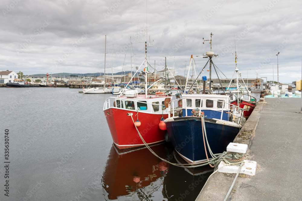 Fishing boats in the dock. Harbor in Ireland.