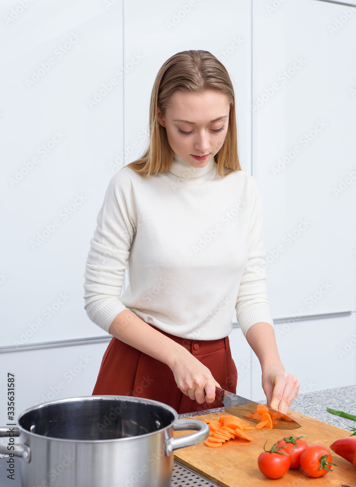 young woman cooking in kitchen