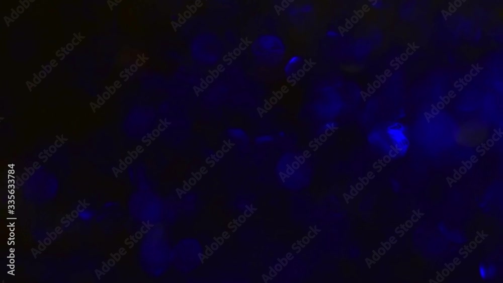Close-up beautiful blue and red shiny sparkles flicker in the dark Close-up beautiful blue and red shiny sparkles flicker in the dark