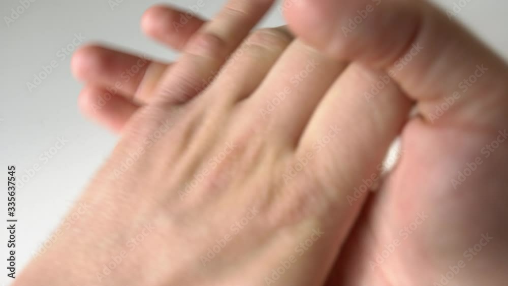 Closeup of pouring white screen into the hands and applying it all over the hands. Applying mineral screen on the hands. Cosmetic procedure and skin care. Dry hands. Closeup of pouring white screen into the hands and applying it all over the hands. Applying mineral screen on the hands. Cosmetic procedure and skin care. Dry hands.
