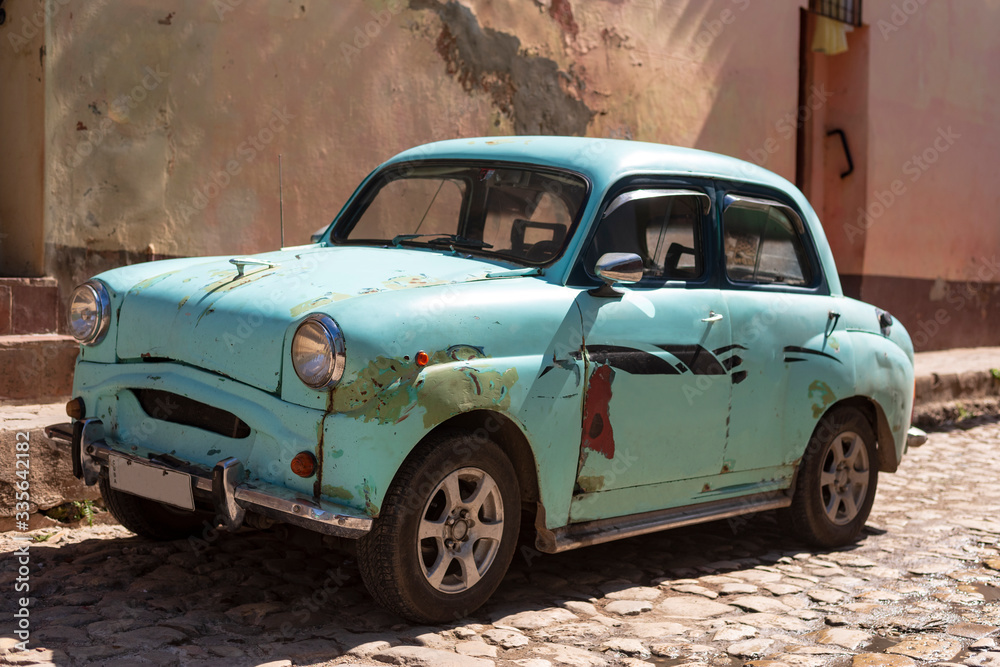 old rusty car in the street of trinidad cuba