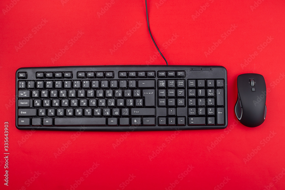 Computer mouse and keyboard on a reddish background. Top view. Computer mouse and keyboard on a reddish background. Top view.
