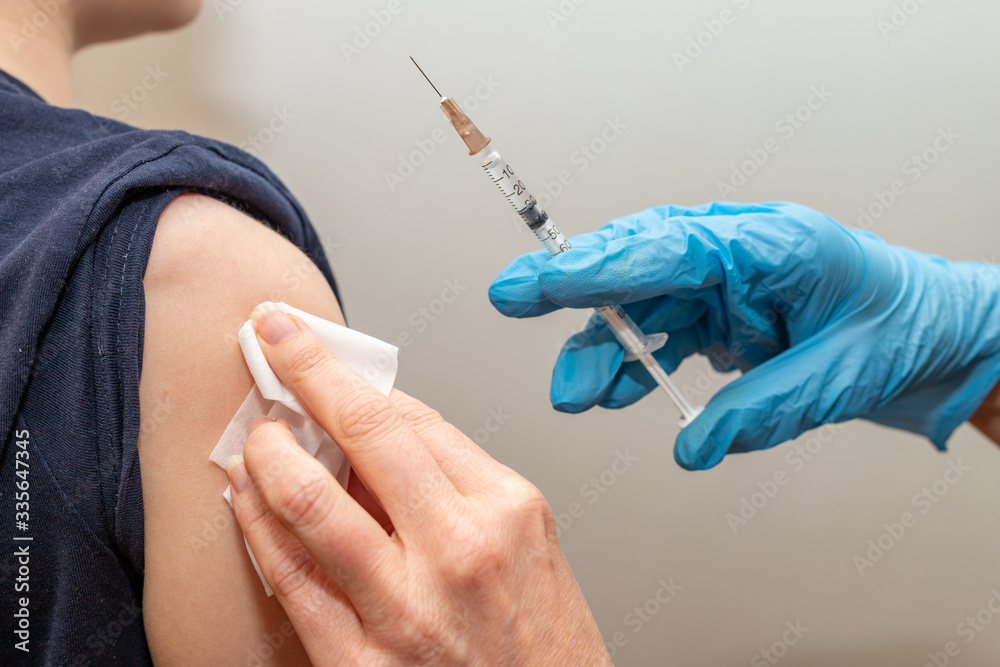 Vaccinating children in the hospital. A syringe with a vaccine in the hands of a nurse. Vaccinating children in the hospital. A syringe with a vaccine in the hands of a nurse.