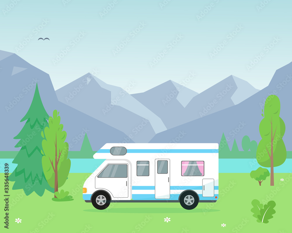 Camping trailer near the lake and mountains.