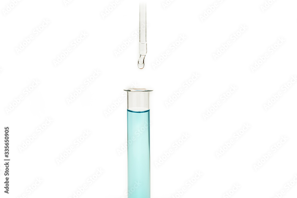 Dripping reagent into test tube with liquid sample Dripping reagent into test tube with liquid sample