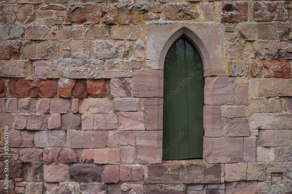 old wooden door in stone wall