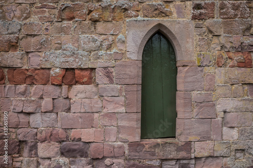 old wooden door in stone wall © roostler