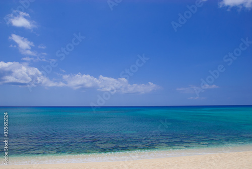 Fototapeta Naklejka Na Ścianę i Meble -  A section of Seven Mile Beach on Grand Cayman in the Cayman Islands. This tropical Caribbean island paradise is a hot spot for affluent tourism 
