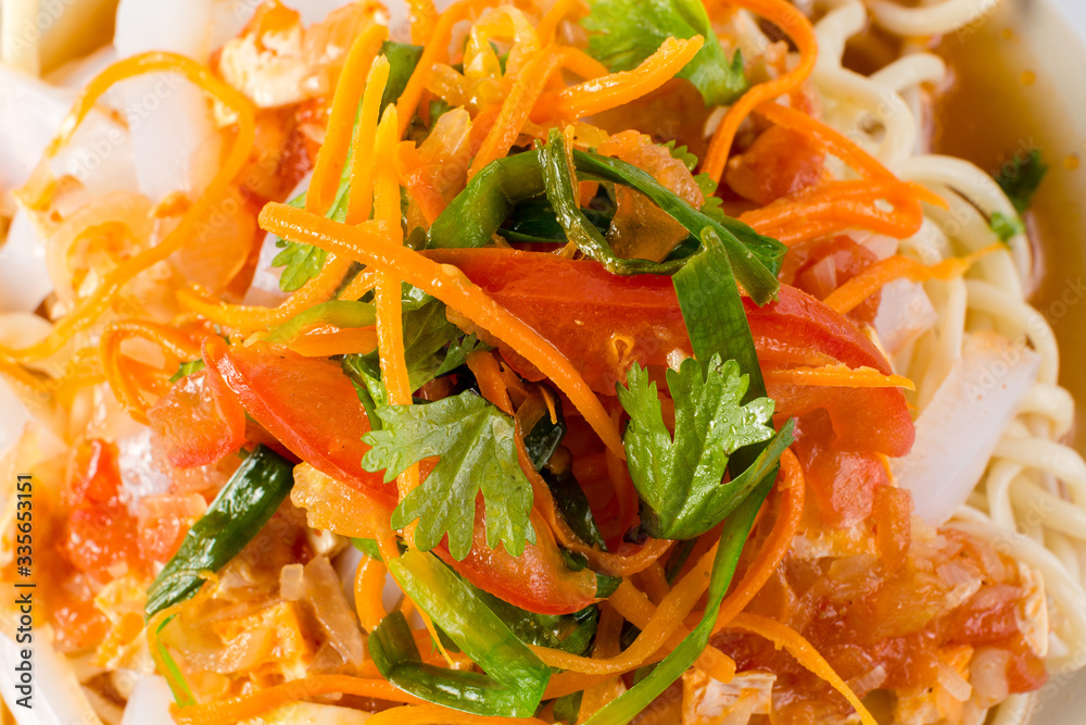 Delicious asian food in take-out box. Close up on noodles with fried vegetables and seafood then stirred soy sauce. Food delivery service. Delicious asian food in take-out box. Close up on noodles with fried vegetables and seafood then stirred soy sauce. Food delivery service.